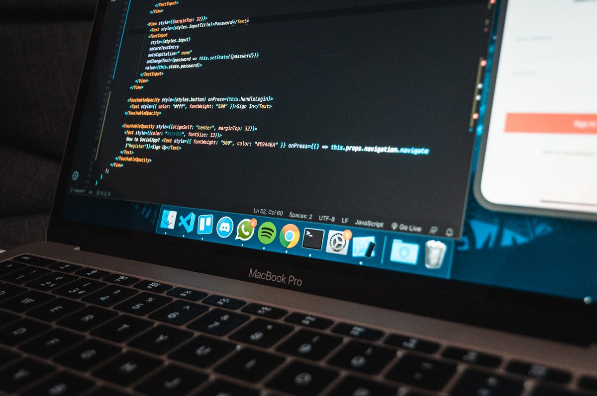 Laptop specs for AI coding tools — modern laptop workspace with program code on screen
